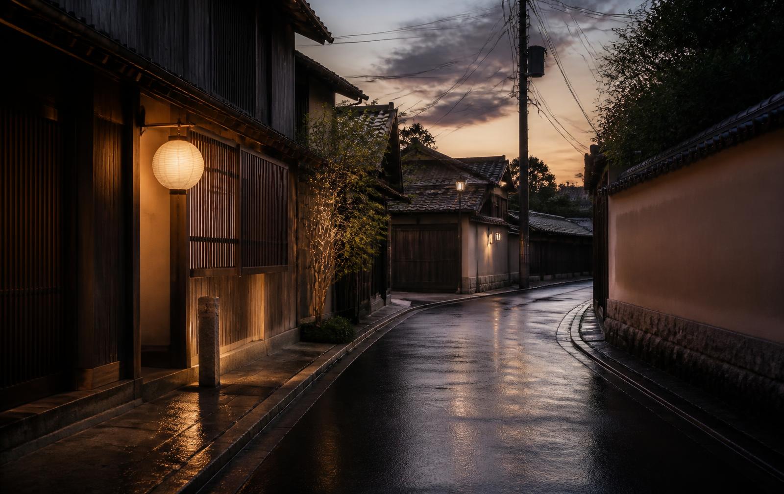 Quiet Japanese street at dusk with lantern light and wet reflections